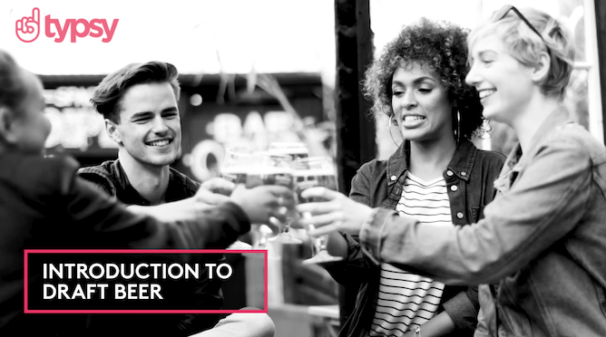 A group of young people toast with draft beer at a pub.