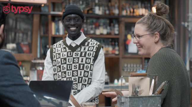 Typsy logo in red in upper left hand corner on image of staff in restaurant, including a smiling young man and woman.