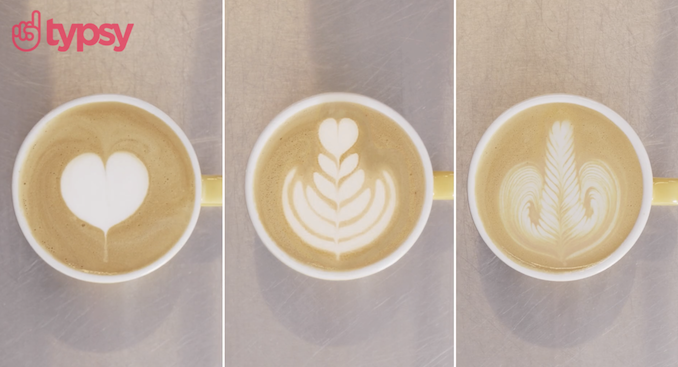 Images of the top of three white coffee cups displaying three different latte designs.