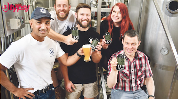 smiling team enjoying a beer together.